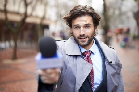Care to comment. Cropped portrait of a handsome news reporter doing an interview.の写真素材