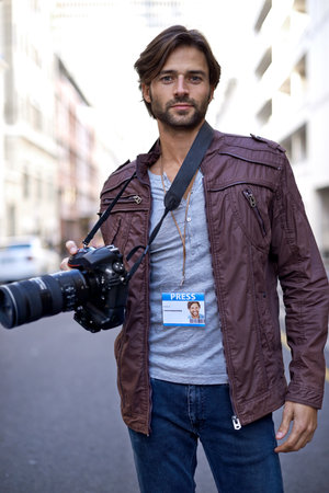 Photography is my passion. a handsome young photographer at work in the city.