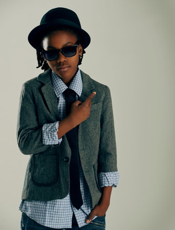 Dressed in his best. Studio portrait of a young ethnic boy with a funky style.の写真素材