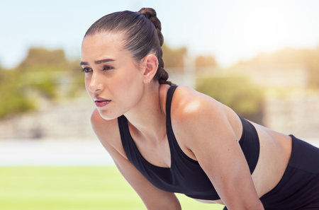 Fitness, health and woman runner at stadium with mindset, vision or goal focus for race, event or...