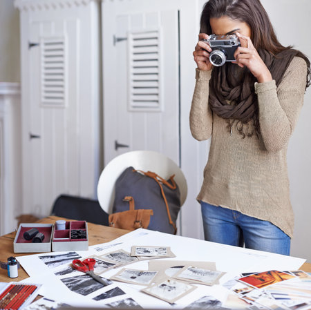 A young photographer taking a snapshot with her camera.の写真素材