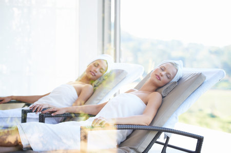 Taking time off for themselves. Two gorgeous young women at the day spa together.の写真素材