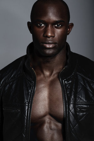 Masculine confidence. A handsome african man modeling clothes in studio.の写真素材