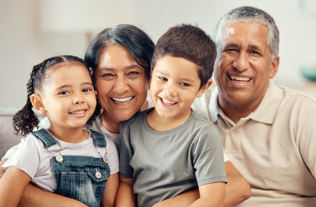 Grandparents portrait, love hug and children with smile for relax on living room sofa, happy in lounge together and family on couch in house. Elderly grandmother and man care for kids in apartmentの写真素材