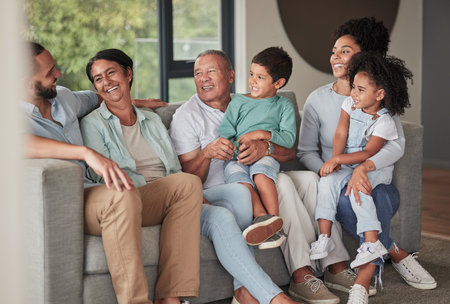 Children, parents and happy grandparents on sofa, generations of family together in living room....