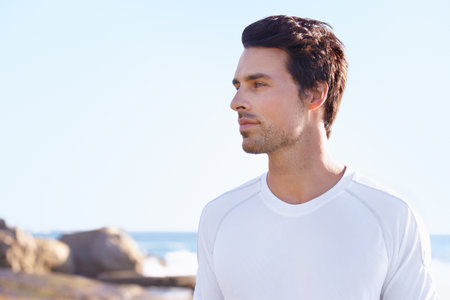 Getting back to nature. a young man enjoying a day at the ocean.の写真素材