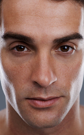 He just oozes confidence. Closeup studio portrait of a handsome young man.の写真素材