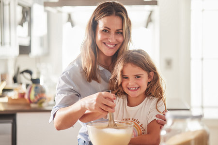Love, mother and child in kitchen cooking together for parent bonding leisure in New Zealand home....