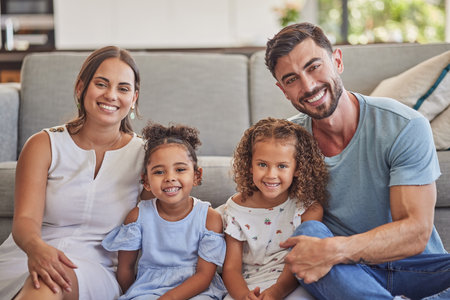 Portrait, happy family in home living room and smile bonding together by sofa. Love, relax and caring parents or dad, mom and girls from Spain spending quality time, care and support in house loungeの写真素材
