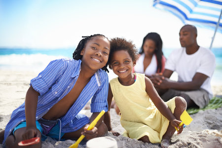 Sibling fun. An african-american family enjoying a day at the beach.の写真素材