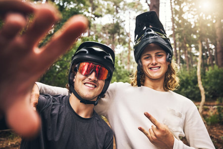 Forest, cycling and friends take a selfie in nature on an outdoor bicycle adventure in the woods in summer. Sports, bikers and happy men in a picture for fun biking memories on holiday vacationの写真素材
