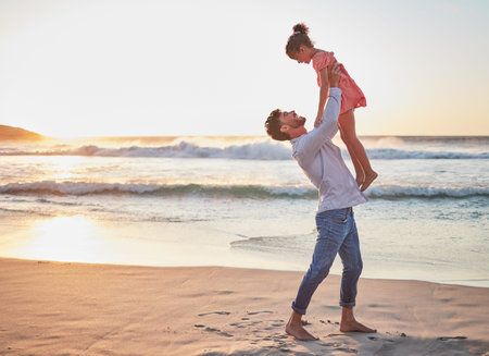 Father, girl and happy at the beach during sunset while play, energy and love during summer vacation in Hawaii. Man, child and energy with mockup space and care on family travel holiday at the seaの写真素材