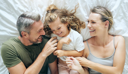 Happy family, bedroom and above child smile, play or enjoy bonding together at house or home. Funny...