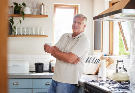 Happy, coffee and retirement with man in kitchen in the morning for breakfast, cooking or health....