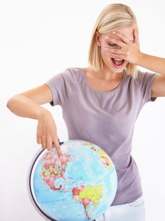 Where am I headed to next. A pretty young woman covering her eyes and pointing at her next...