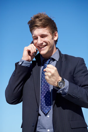 I got the deal Excellent. Young businessman receiving a phone call of good news.の写真素材