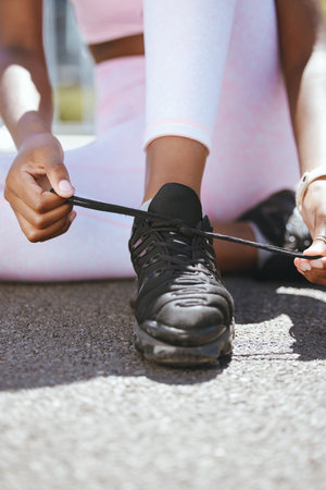 Start, runner woman and shoes tie preparation for cardio workout and active lifestyle closeup....