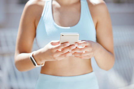 Hands of exercise woman typing on a phone, check fitness app or step tracker for exercise support on...