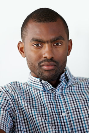 Hes got what it takes to succeed. Portrait of a serious African American man against a white background.の写真素材
