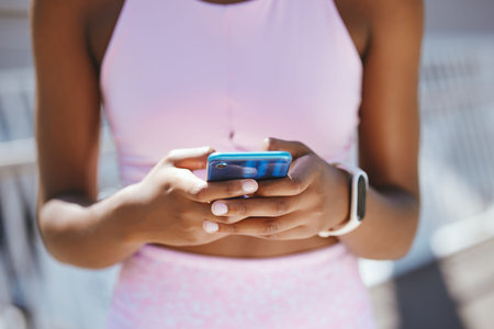 Hands, phone and black woman texting during workout outdoor, social media and internet browsing....
