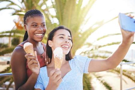 Ice cream, friends and selfie on a phone in a city, bonding and eating while having fun in summer...