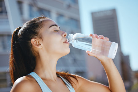 Relax, fitness and water drink girl on hydration break with outdoor summer cardio workout training....