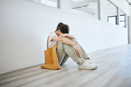 Depression, stress and woman on the floor on an office, frustrated and suffering with mental health problem. Burnout, anxiety and pressure by jobless female feeling hopeless looking for a jobの写真素材