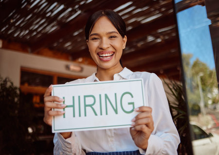 Recruitment, hiring sign and small business owner advertising a job at her coffee shop or...