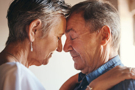 Love, support and elderly couple hug, commitment and understanding in their home together. Wellness,...