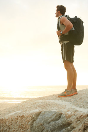 Taking in the view. Young hiker standing and looking at the view.の写真素材