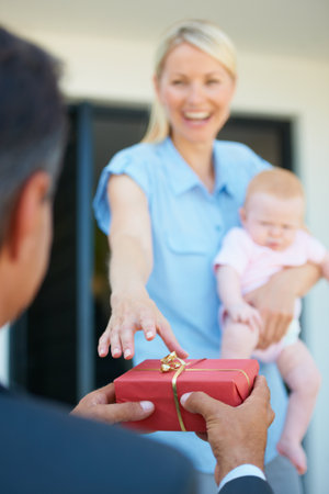 She loves surprises. a man surprising his wife with a gift.の写真素材