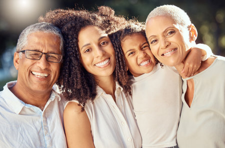 Happy family of grandparents, mother and girl love to smile, together for support, trust and care outdoor. Group of people of senior couple, mom and young child hug in solidarity, happiness and joyの写真素材