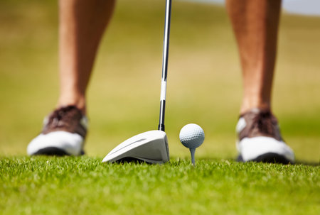 Driving it to the green. Cropped image of a golfer about to smack the golfball down the fairway.の写真素材