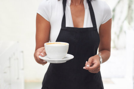 Shes got what you need. a waitress carrying a cup of coffee.の写真素材