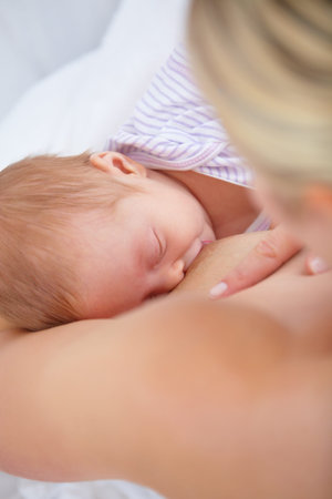 Peaceful moment. High angle shot of a mother breastfeeding her newborn baby.