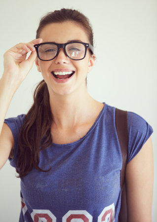 Natural hipster. Portrait of an attractive young woman wearing spectacles.の写真素材