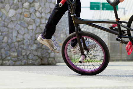 Showing off his skill. A cropped view of a cyclist doing a trick on his bicycle.の写真素材