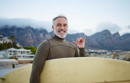 Senior surfer, surfing at beach for fitness and exercise in retirement on an island travel holiday....