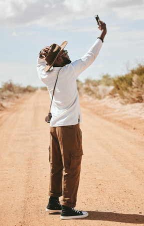 Selfie, black man and outdoor with summer look travelling on dirt road being relax, cool or...