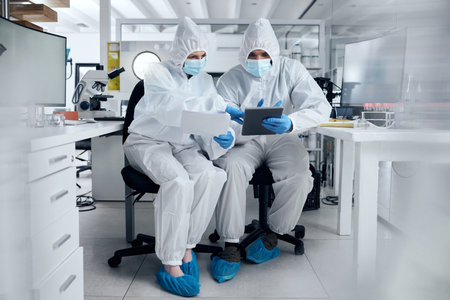 Scientist, covid and team planning research document in laboratory medical safety and protection corona virus results. Man and woman healthcare science doctors in covid 19 tech paperwork partnershipの写真素材