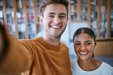Portrait, students and selfie in a library with friends, relax and study together at university campus. Education, learning and classroom student bond and having fun, on break from exam preparationの写真素材