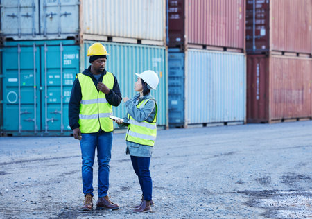 Shipping, logistics and supply chain with a man and woman courier talking in a container port for...