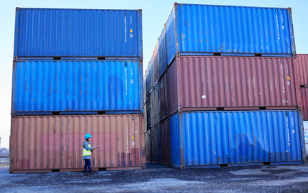 Logistics, supply chain and woman in container port checking inventory list for global freight...