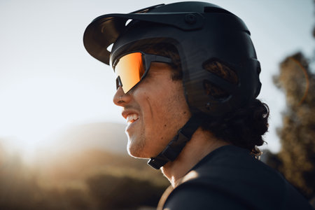 Safety, gear and motorcycle man with helmet and sunglasses in nature forest for outdoor adventure, travel or training with sky sunshine mockup. Healthy sports biking person in the woods for exerciseの写真素材