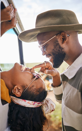 Love, happy and black couple nose touch for playful road trip bonding moment together in nature. Black woman and African man in romantic relationship enjoy travel adventure fun in South Africa.の写真素材