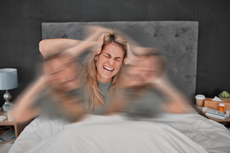 Mental health, bipolar disorder and depressed woman in bed with blur motion showing sad, headache or...