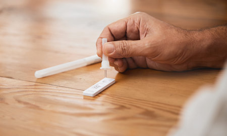 Hands, covid antigen test or dropper in home kit, house or living room for healthcare insurance or...
