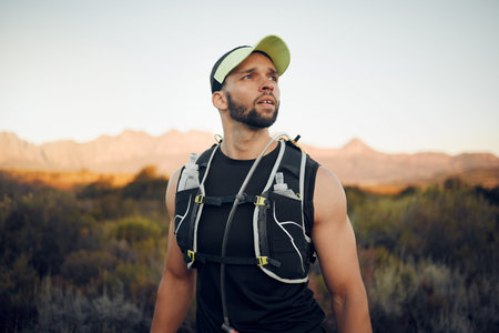 Wellness, man and athlete focus in nature for exercise, view and training in sportswear outdoor....