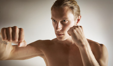 Bare-fisted boxing. a handsome young male boxing bare-fisted.の写真素材