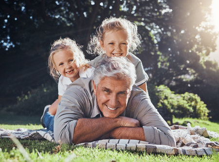 Grandfather, children and portrait of family in the park together with smile during summer in Australia. Girl kids and senior man playing, happy and having fun in a green garden in nature with careの写真素材